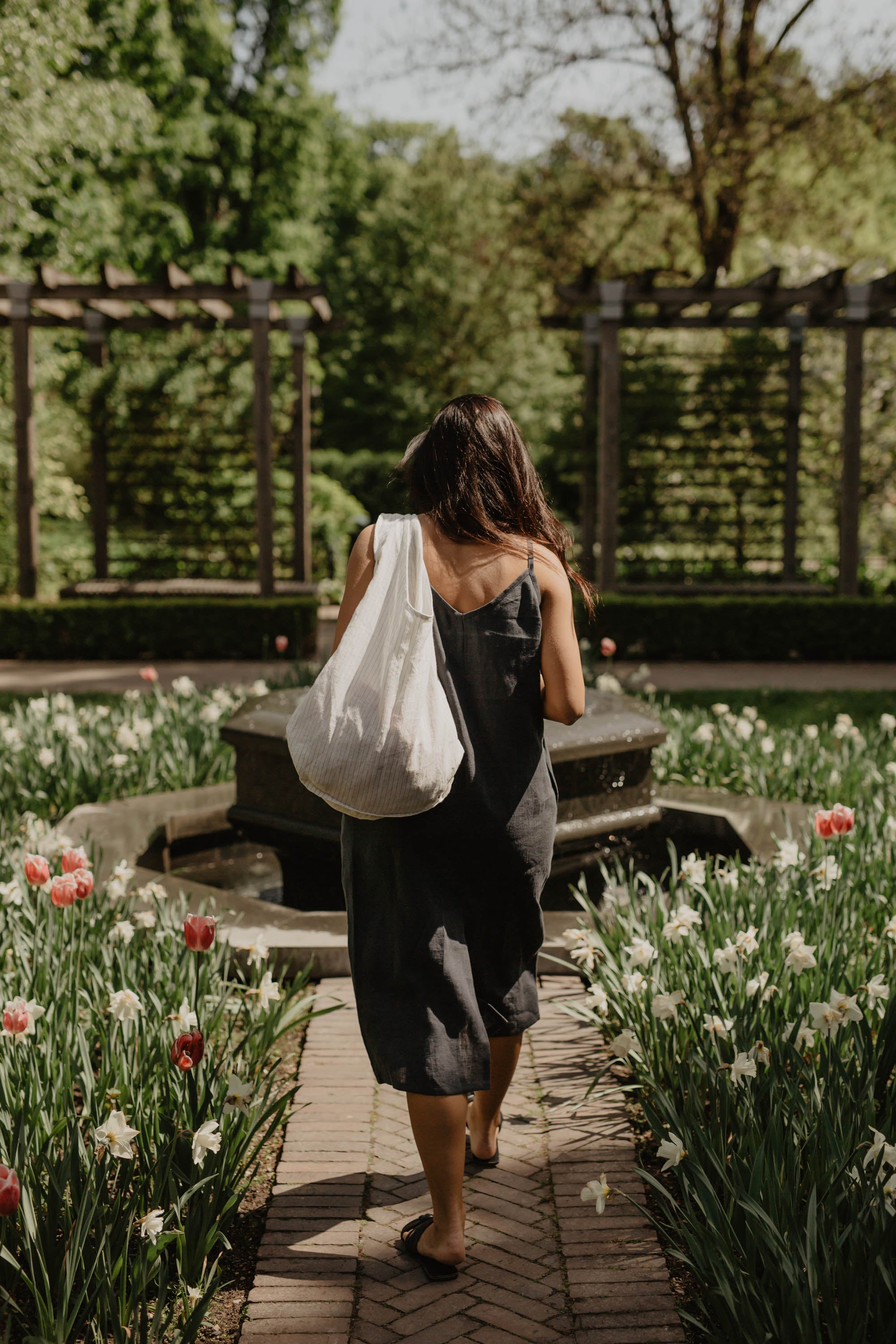 Woman Facing Back In A Park With A White Linen Tote Bag By Amourlinen