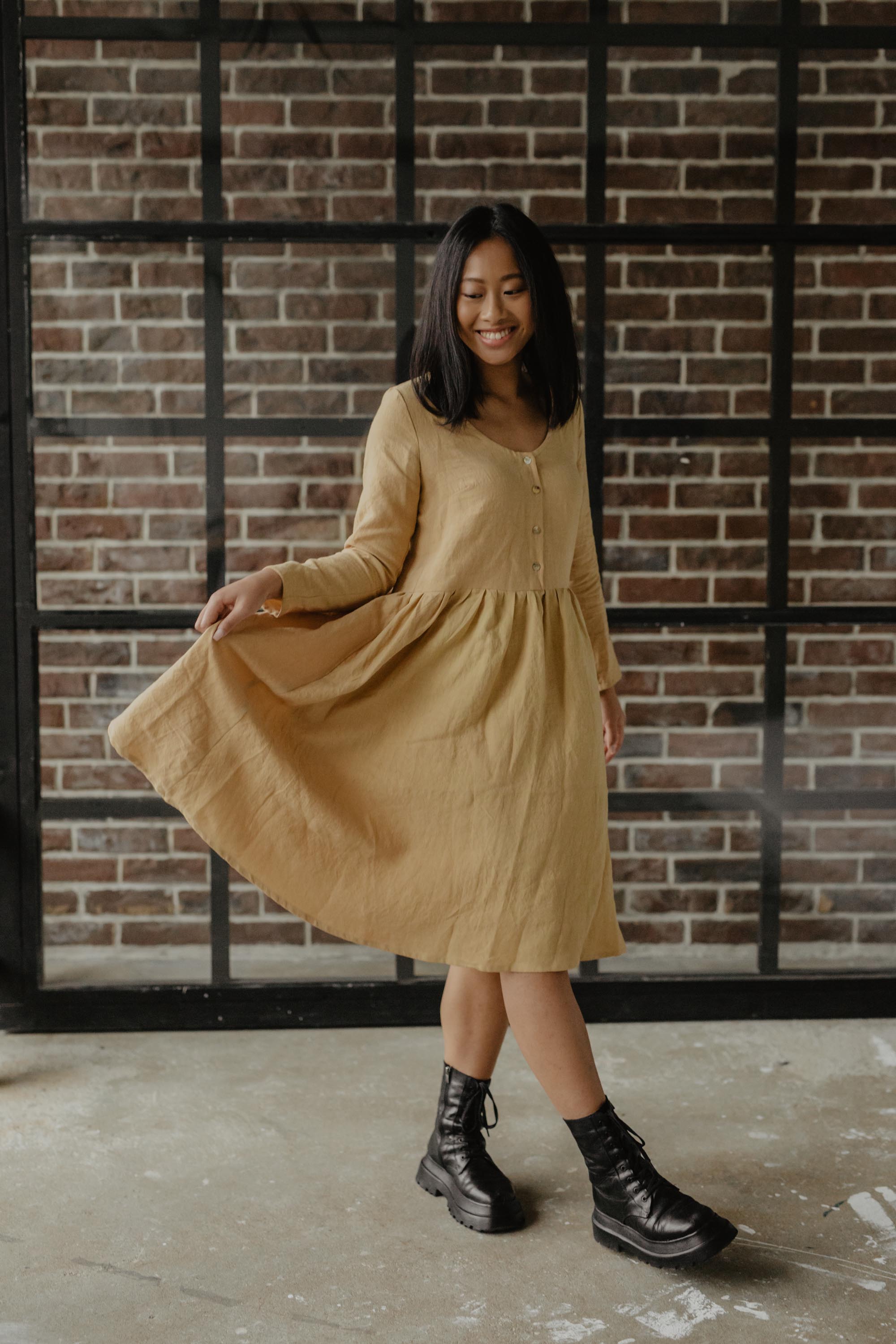 Woman Posing In Mustard Mid-length Linen Dress By AmourLinen