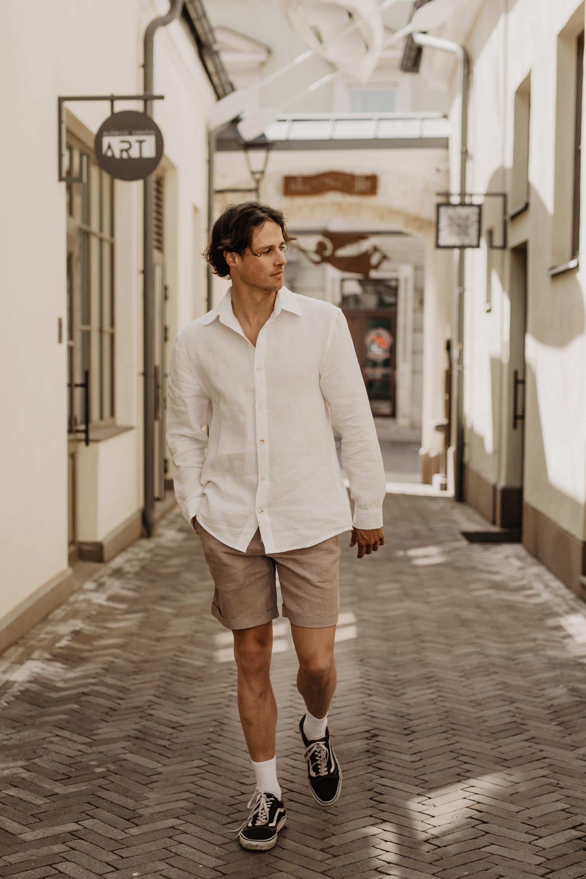 Man Wearing Classic Linen White Shirt Walking Up A Street