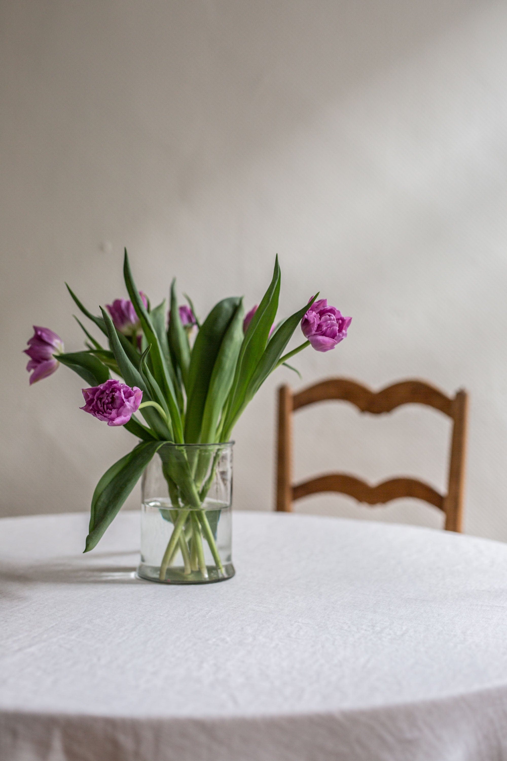 Flowers Pot on top of White Linen Round Tablecloth By AmourlInen