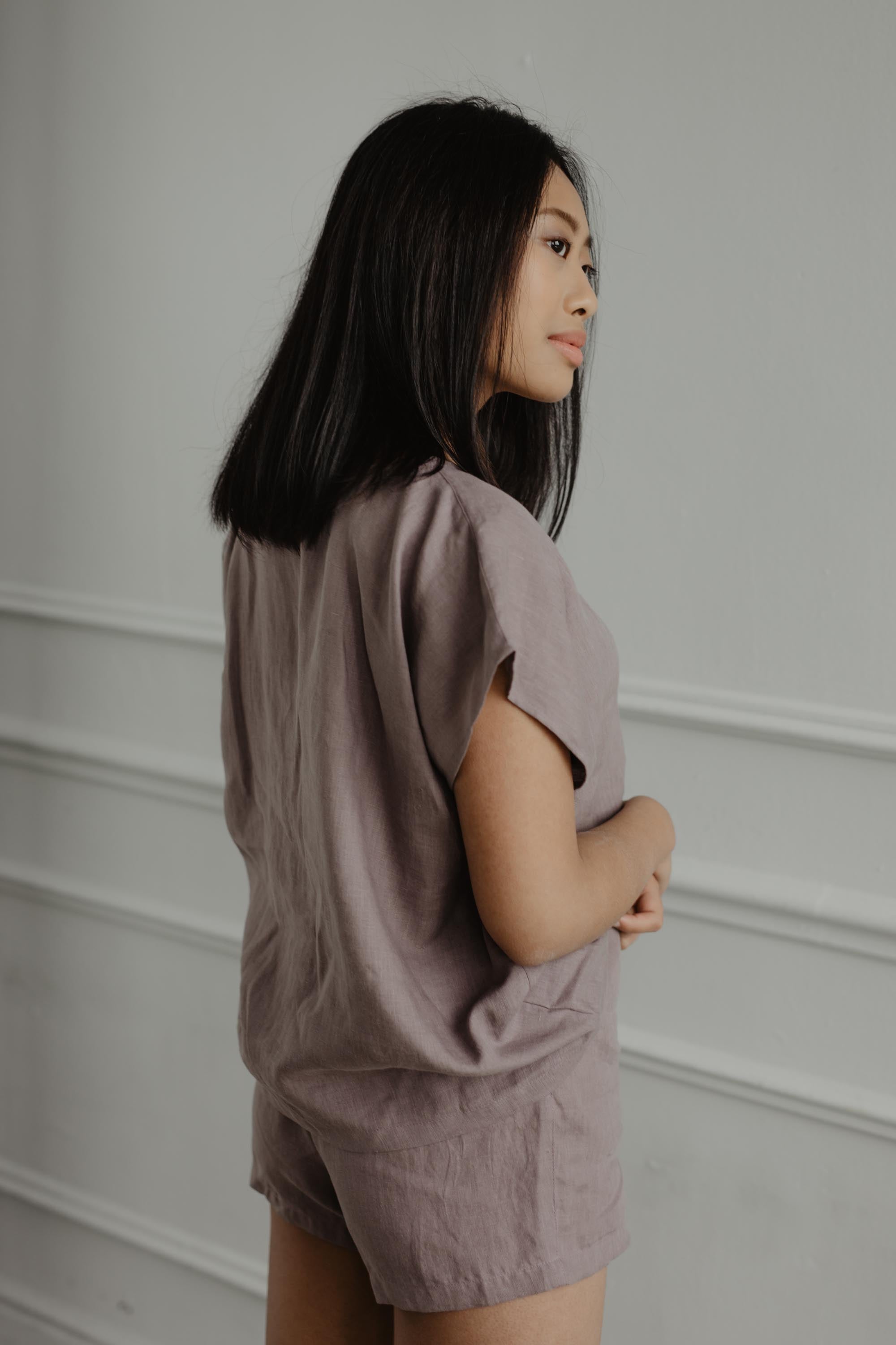 Woman Looking To The Side Wearing A Rosy Brown Linen Short Sleeve Pajama Set