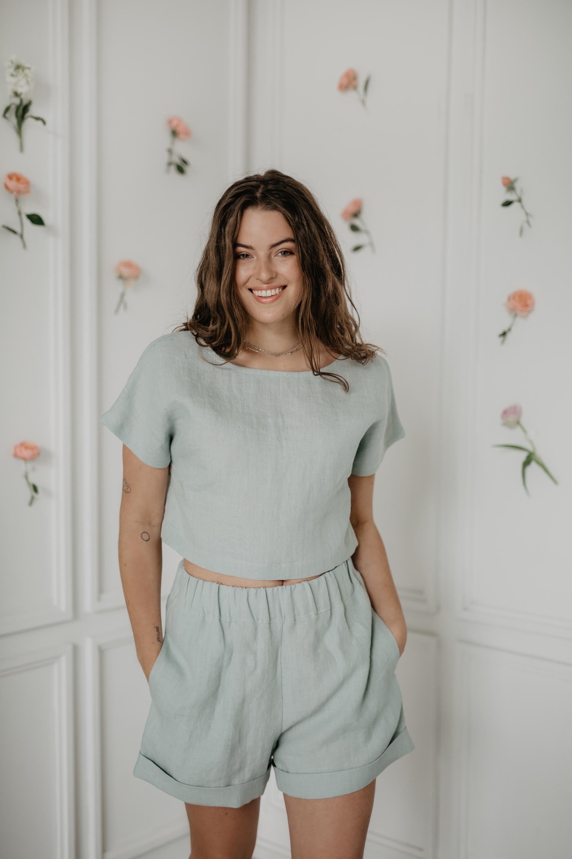 Woman Wearing Sage Green Linen Shorts And Sage Green Linen Top
