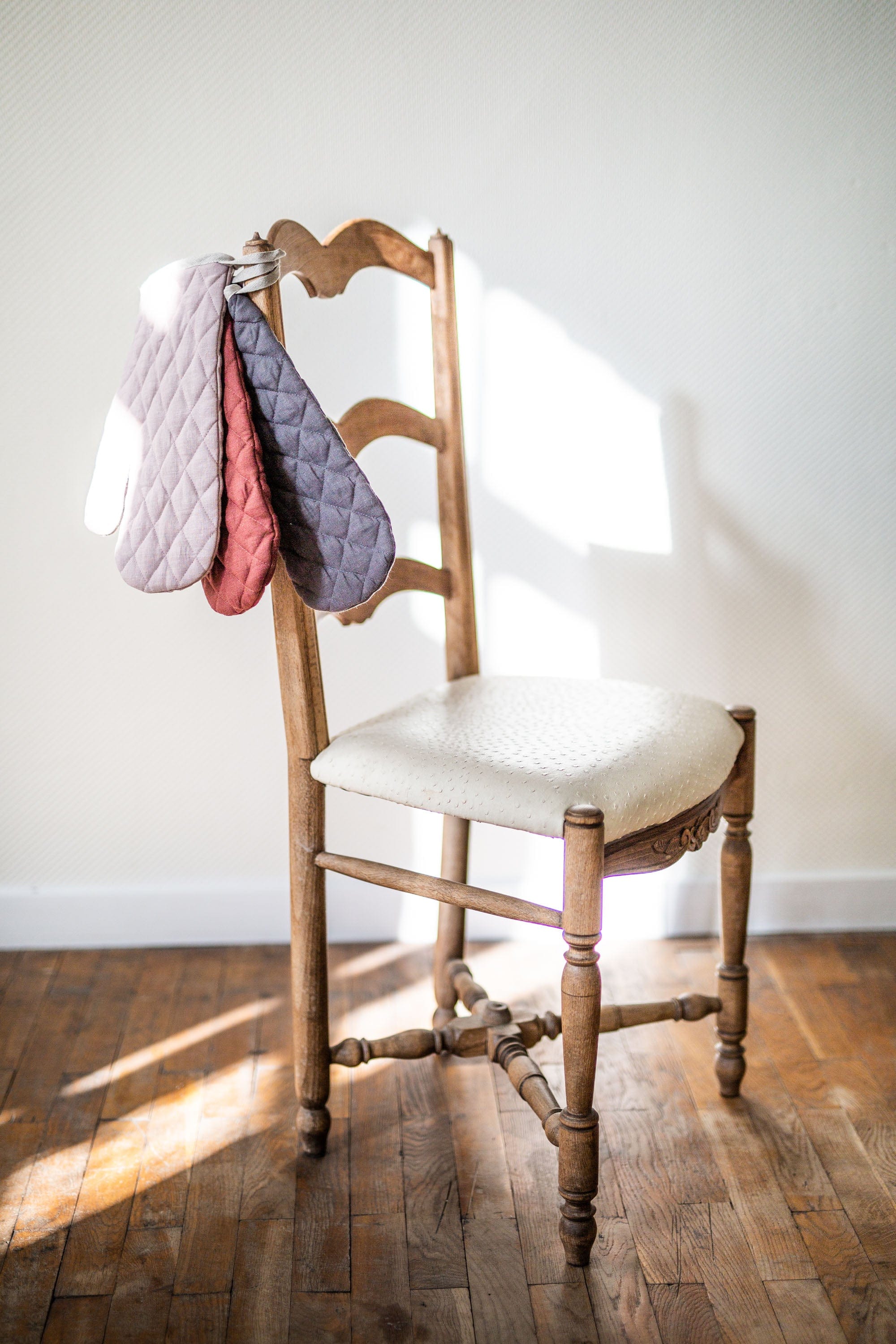 Various Color Linen Oven Mitts hanging on chair By Amourlinen