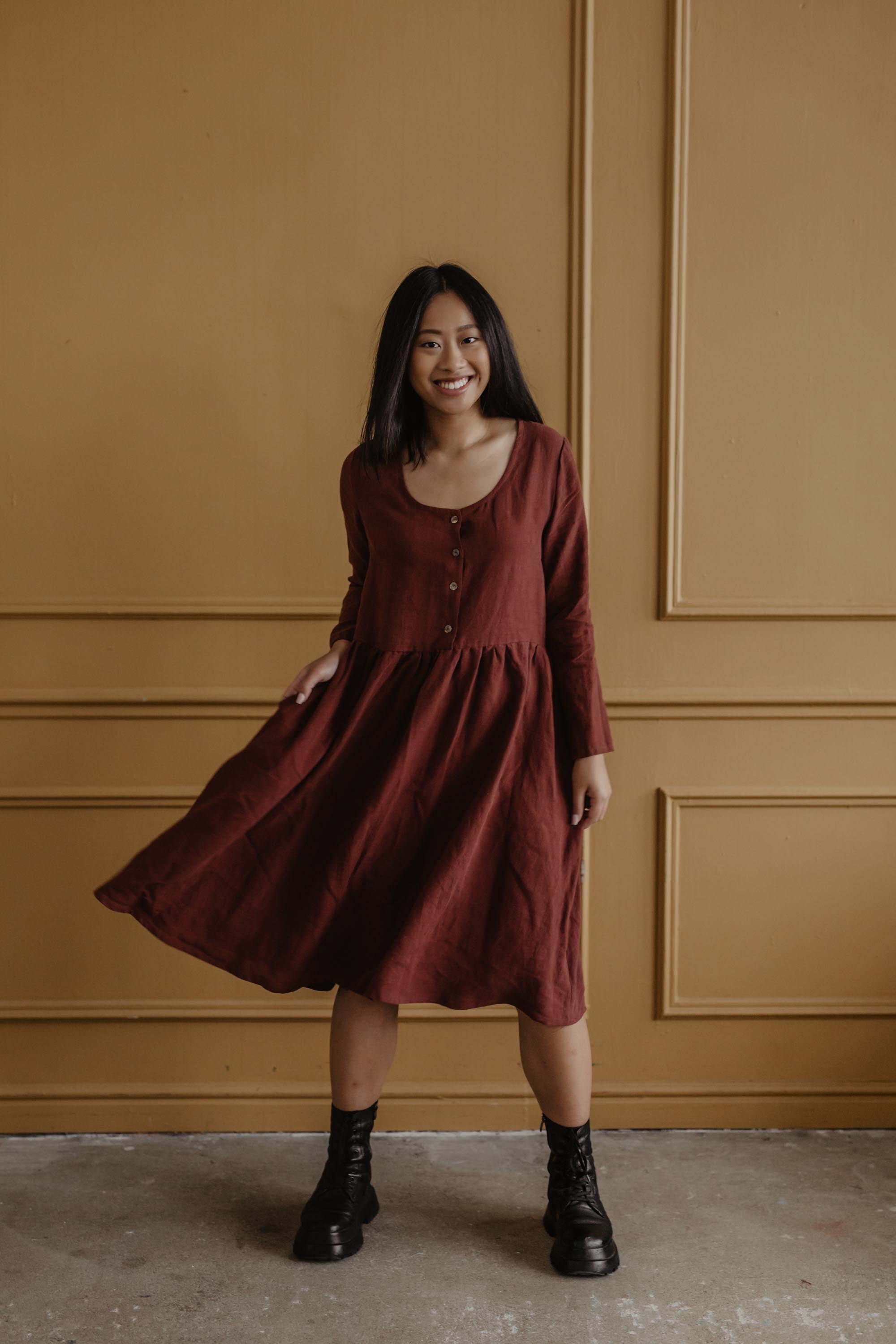 Woman Posing Wearing A Terracotta Mid-Length Linen Dress