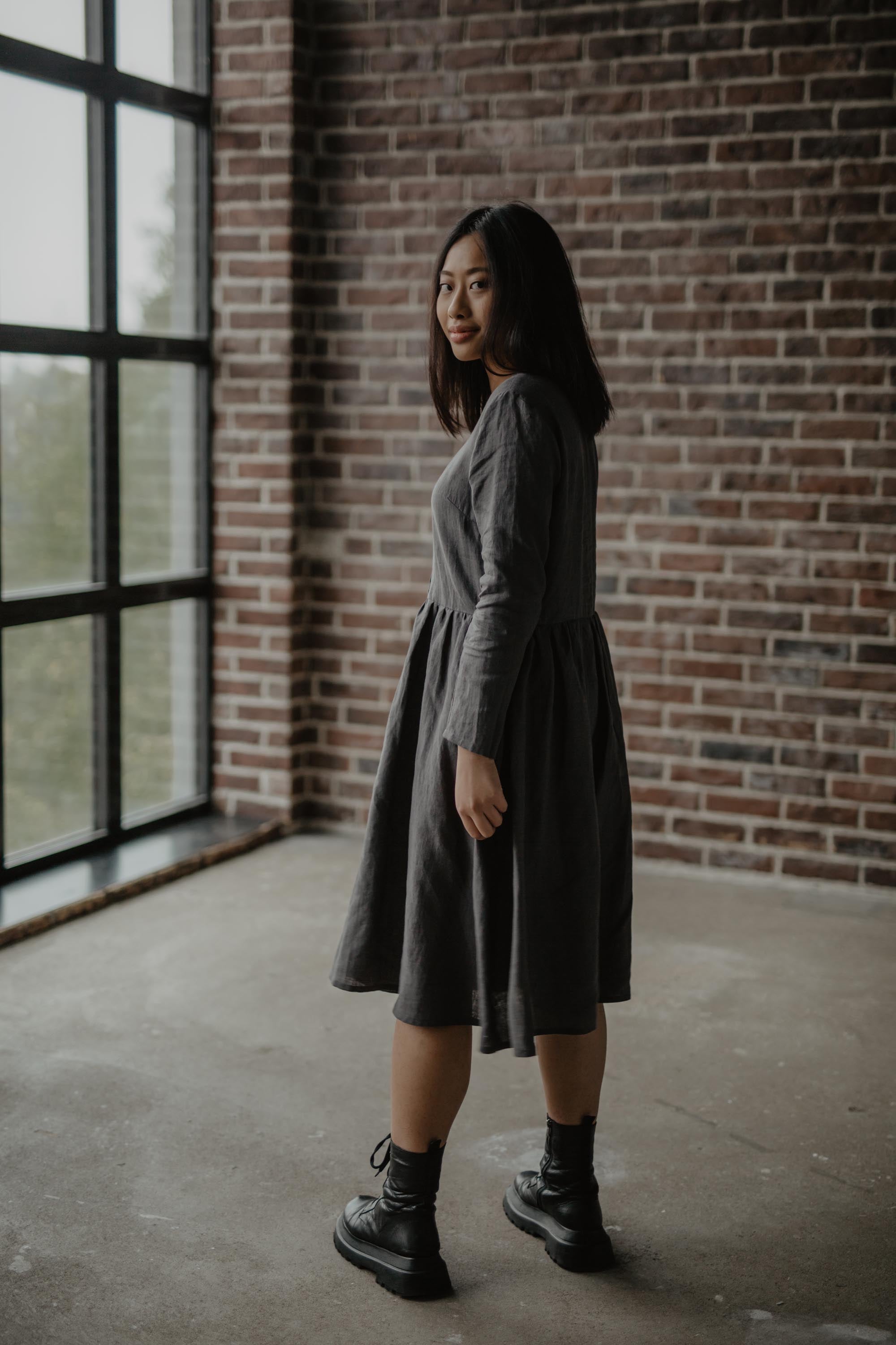 Woman Looking Back Wearing A Charcoal Mid-Length Linen Dress By AmourLinen