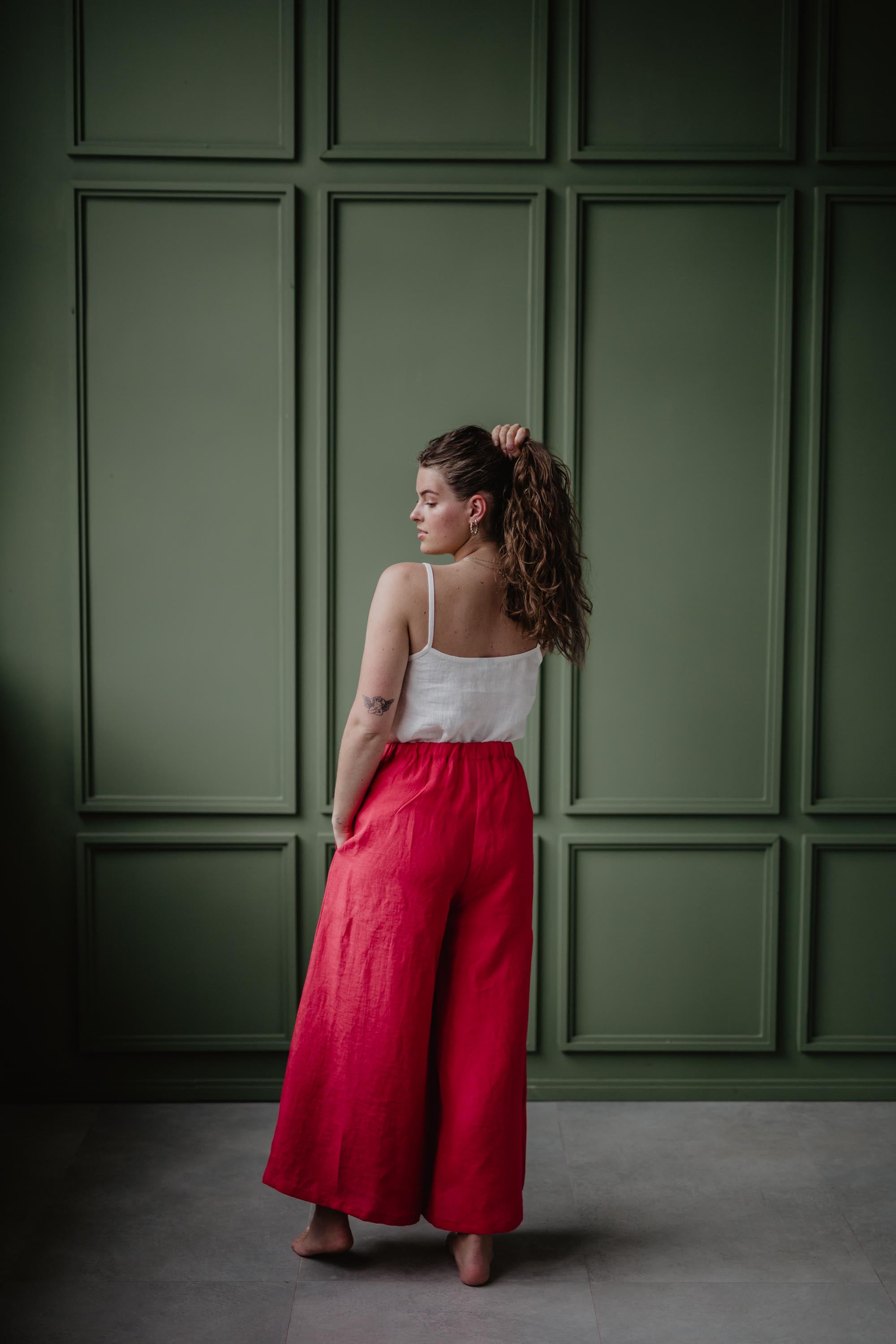 Woman Facing Back Wearing A White Linen Top and Magenta Linen Pants By Amourlinen