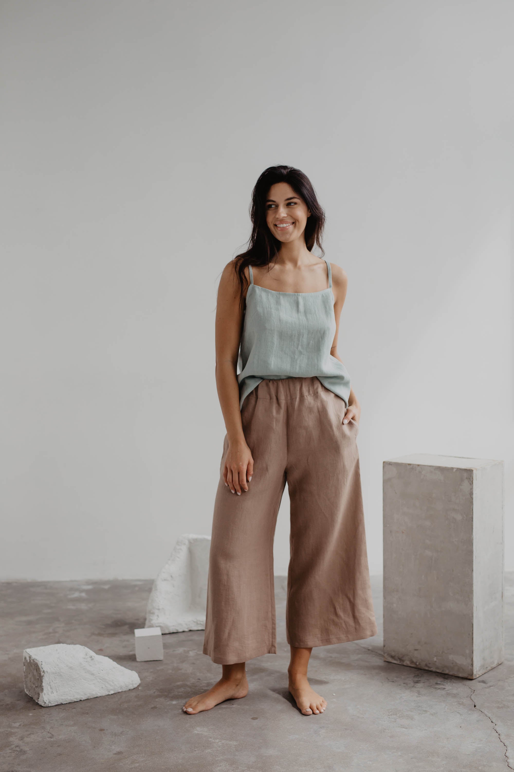 Woman Wearing A Sage Green Linen Top and Dusty Rose Linen Pants By Amourlinen