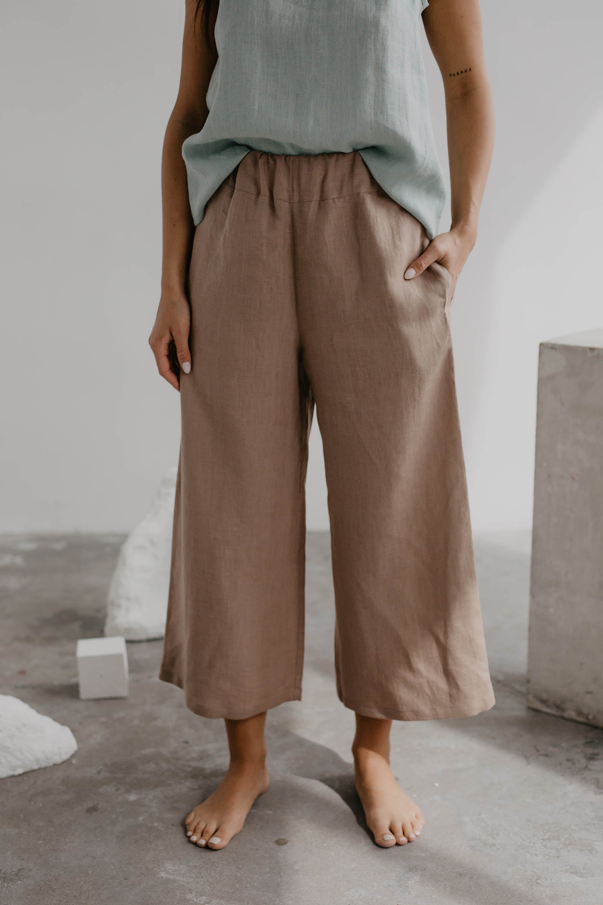 Close Up Of Woman Wearing Dusty Rose Linen Pants and Sage Green Linen Top By Amourlinen
