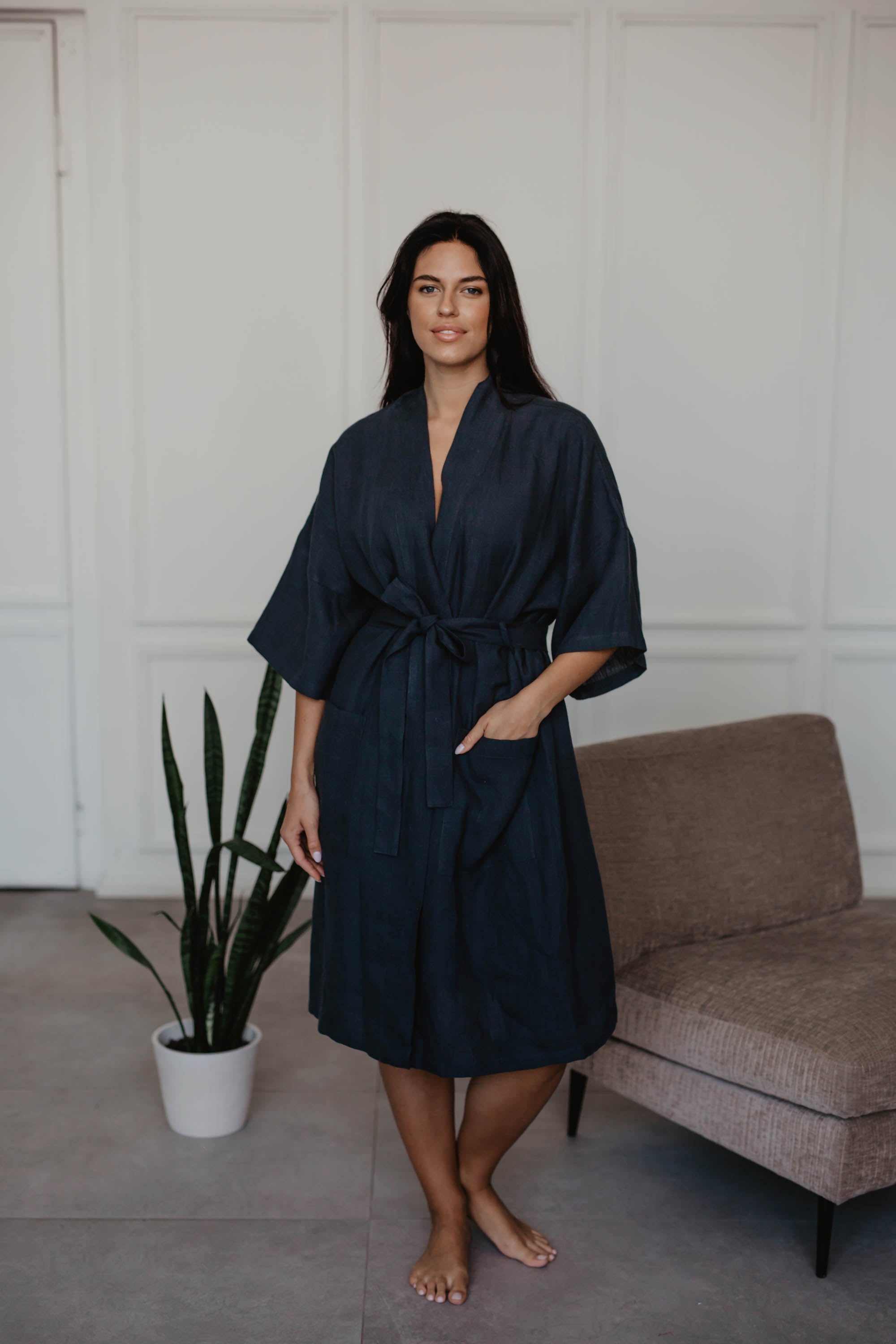 Woman Next To a Sofa Wearing A Dark Linen Bathrobe By AmourLinen