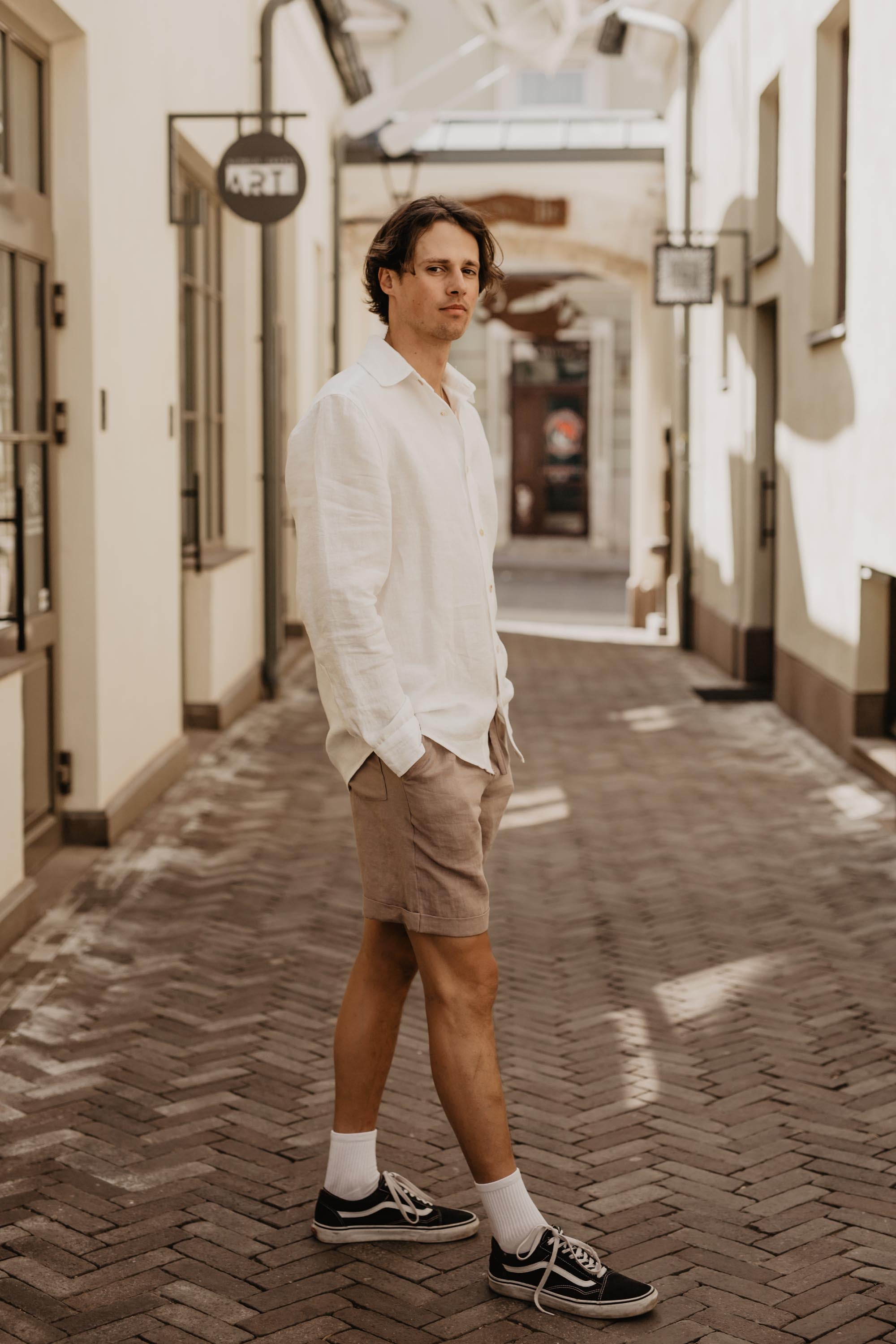 Man Stepping And Looking To The Side Wearing LInen Shorts