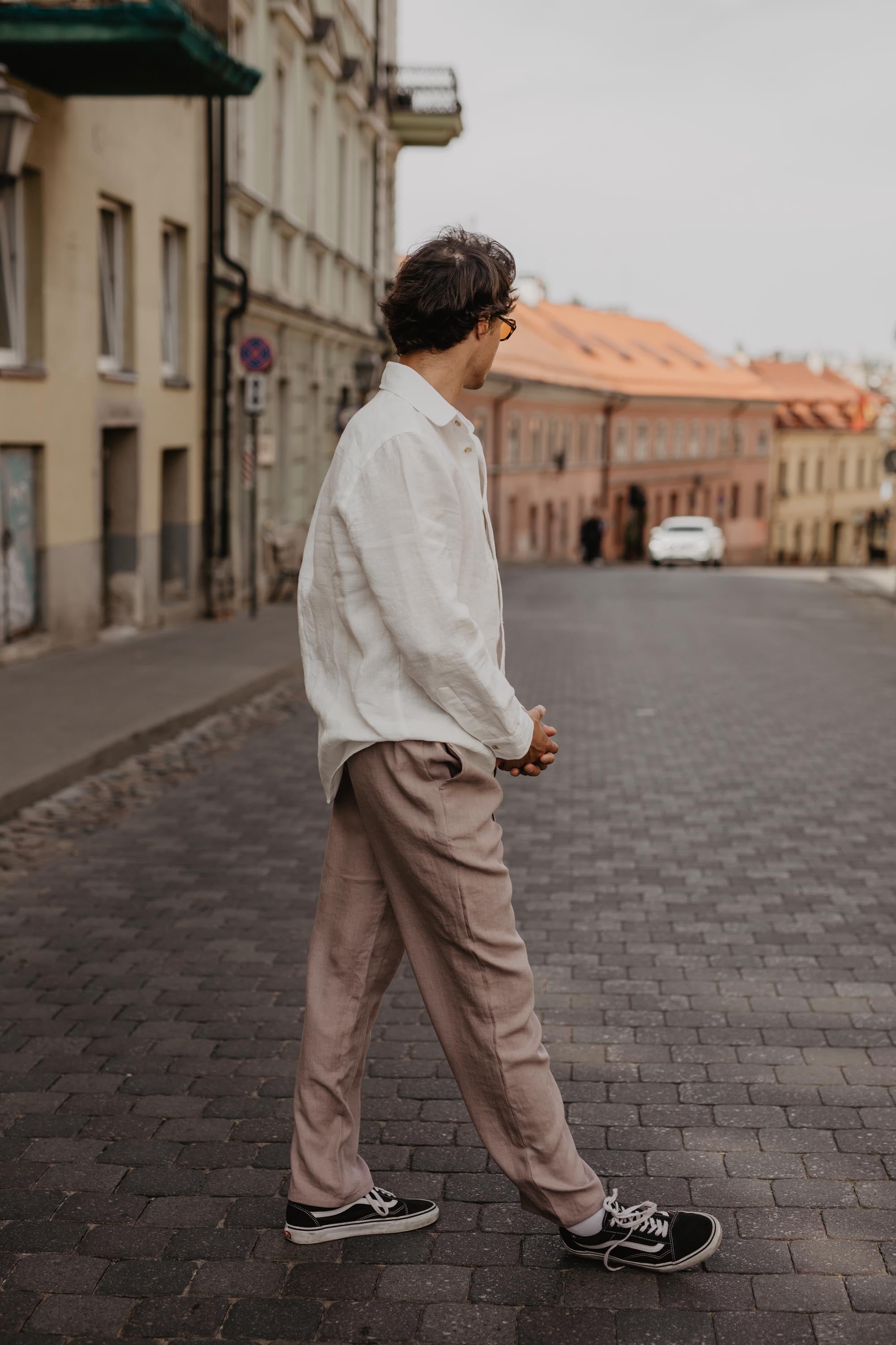 Stylish Man Looking Down A Street Wearing Linen Wear