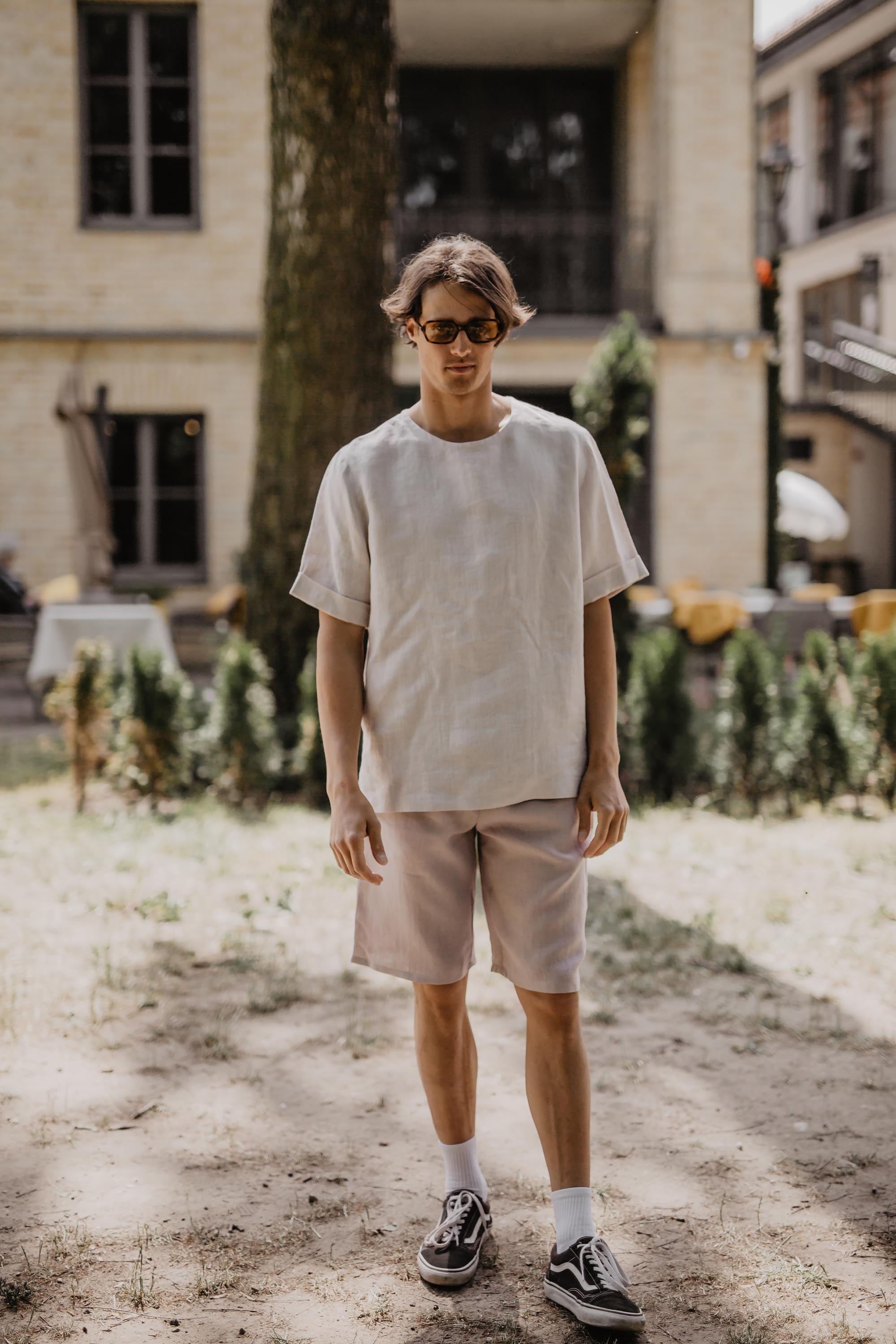 Man Wearing White T-Shirt And Cotton Candy Color Linen Shorts Walking Towards