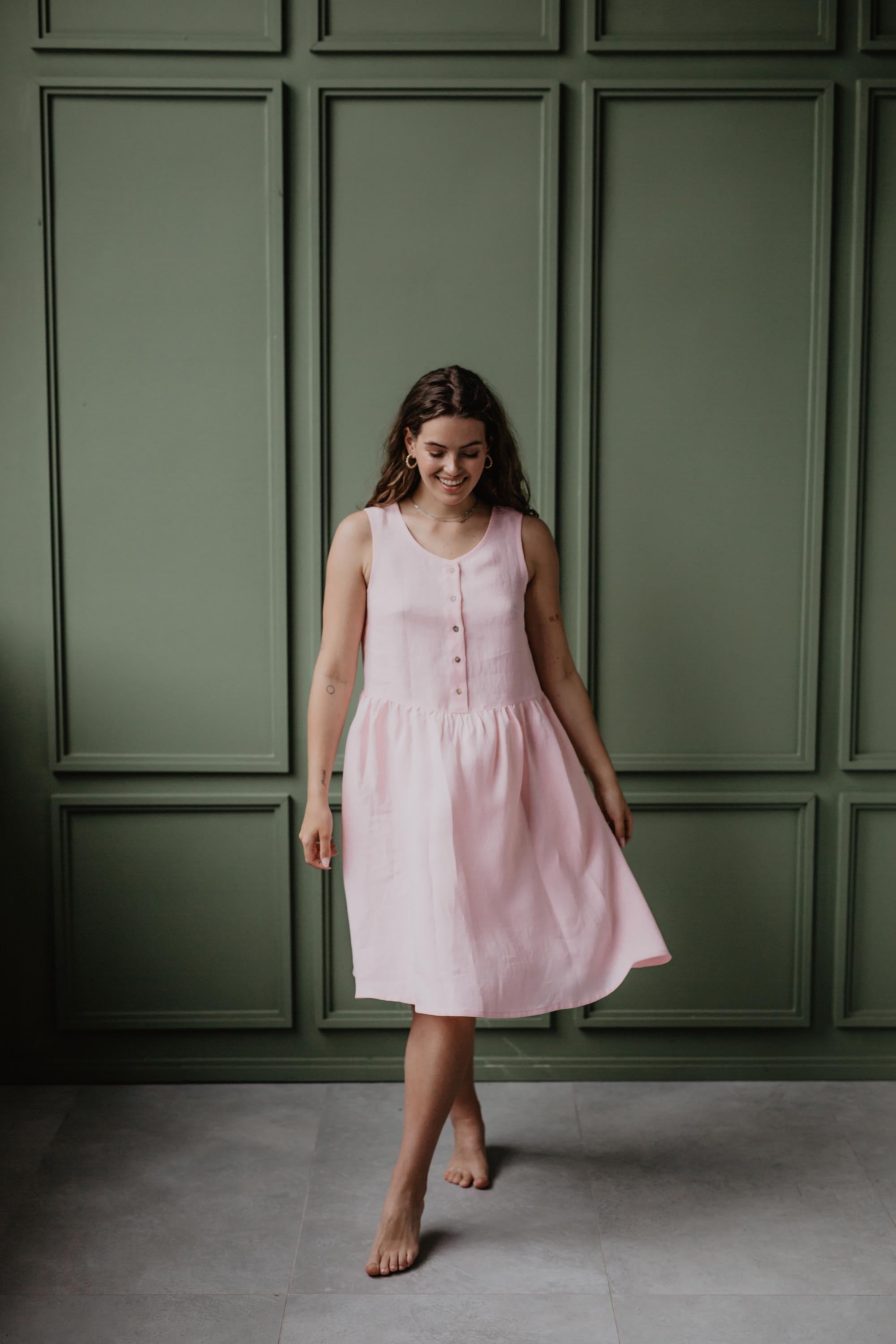 Women Making A Step In A Light Pink Sleeverless Linen Summer Dress by Amourlinen