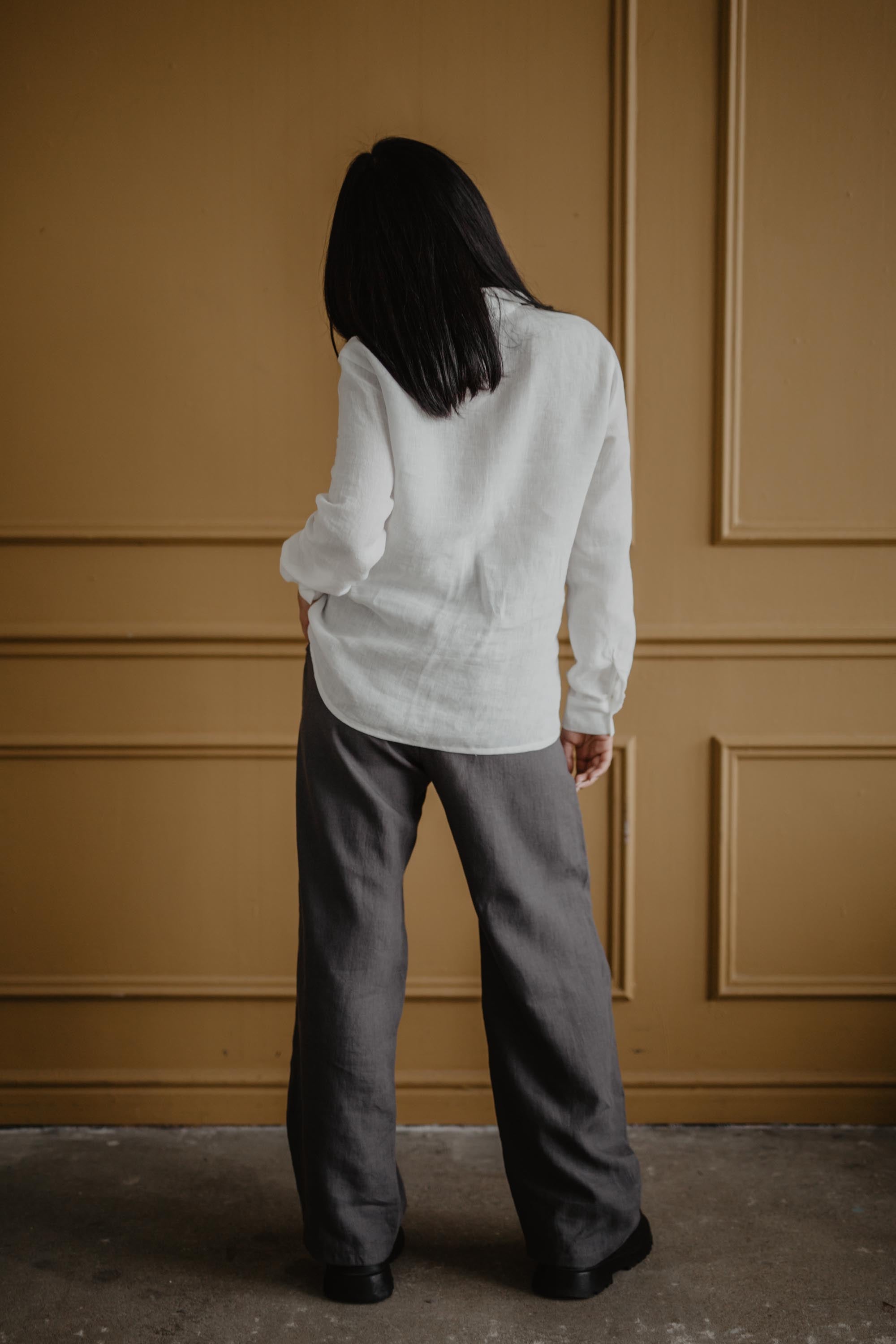 Woman Facing Back Wearing A White classic Linen Shirt By AmourLinen