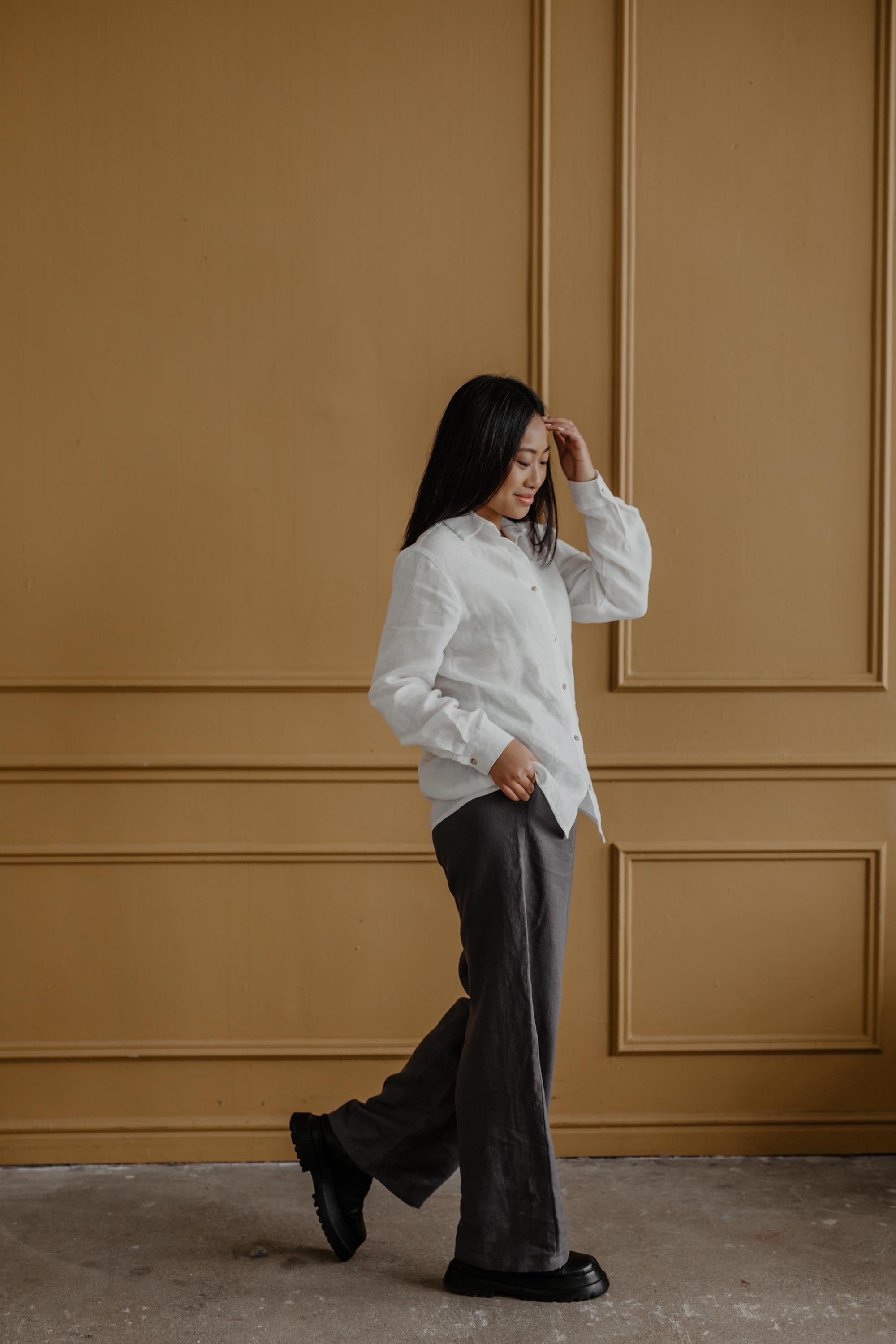 Woman Stepping Wearing a White Classic Linen Shirt By AmourLinen
