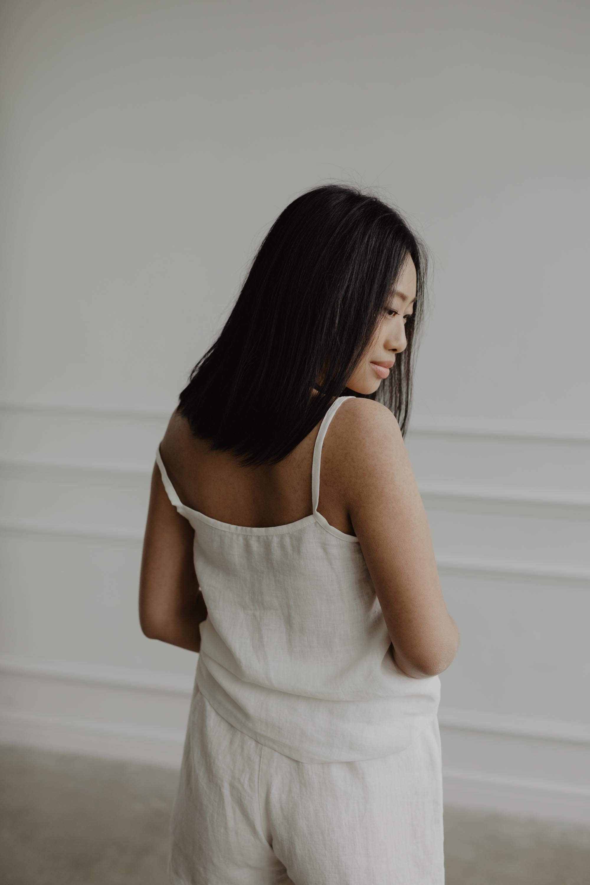 Back Of Woman Wearing A Sleeveless Linen Pajama Set By Amourlinen