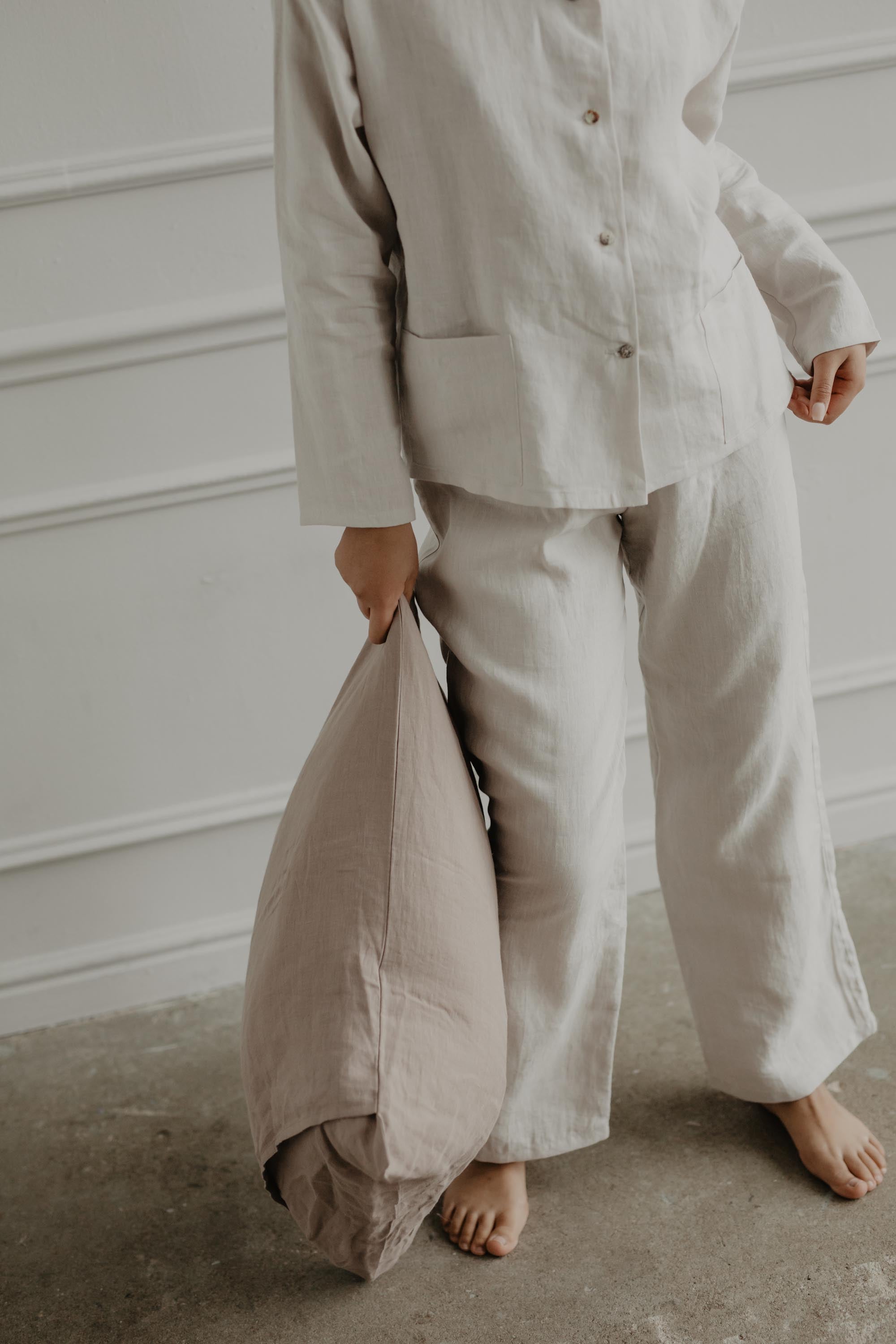 Close Up Of White Linen Long Sleeve Pajama Set and Linen Pillow