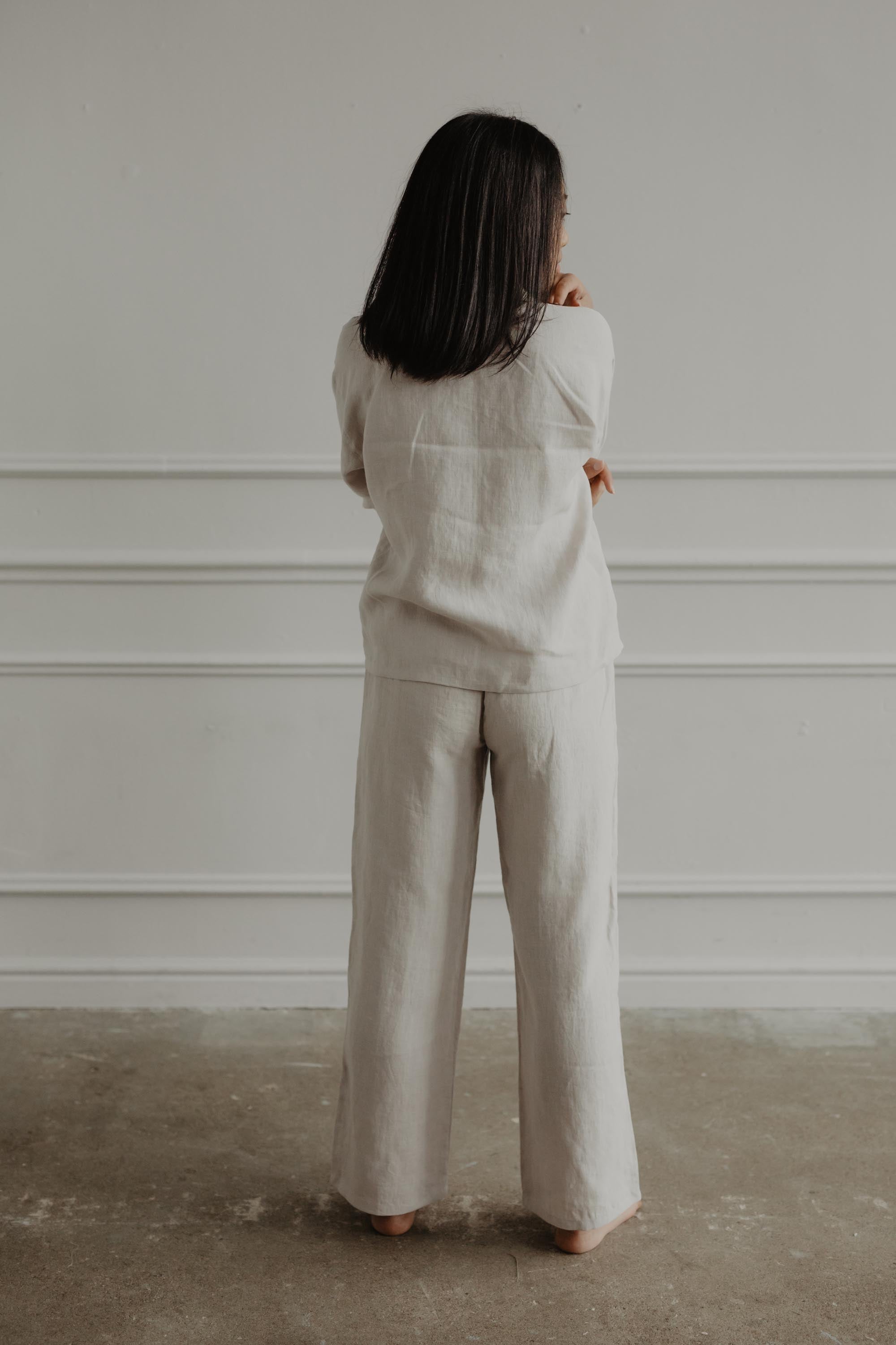 Woman Facing Back Wearing A White Long Sleeve Linen Pajama Set By AmoutLinen
