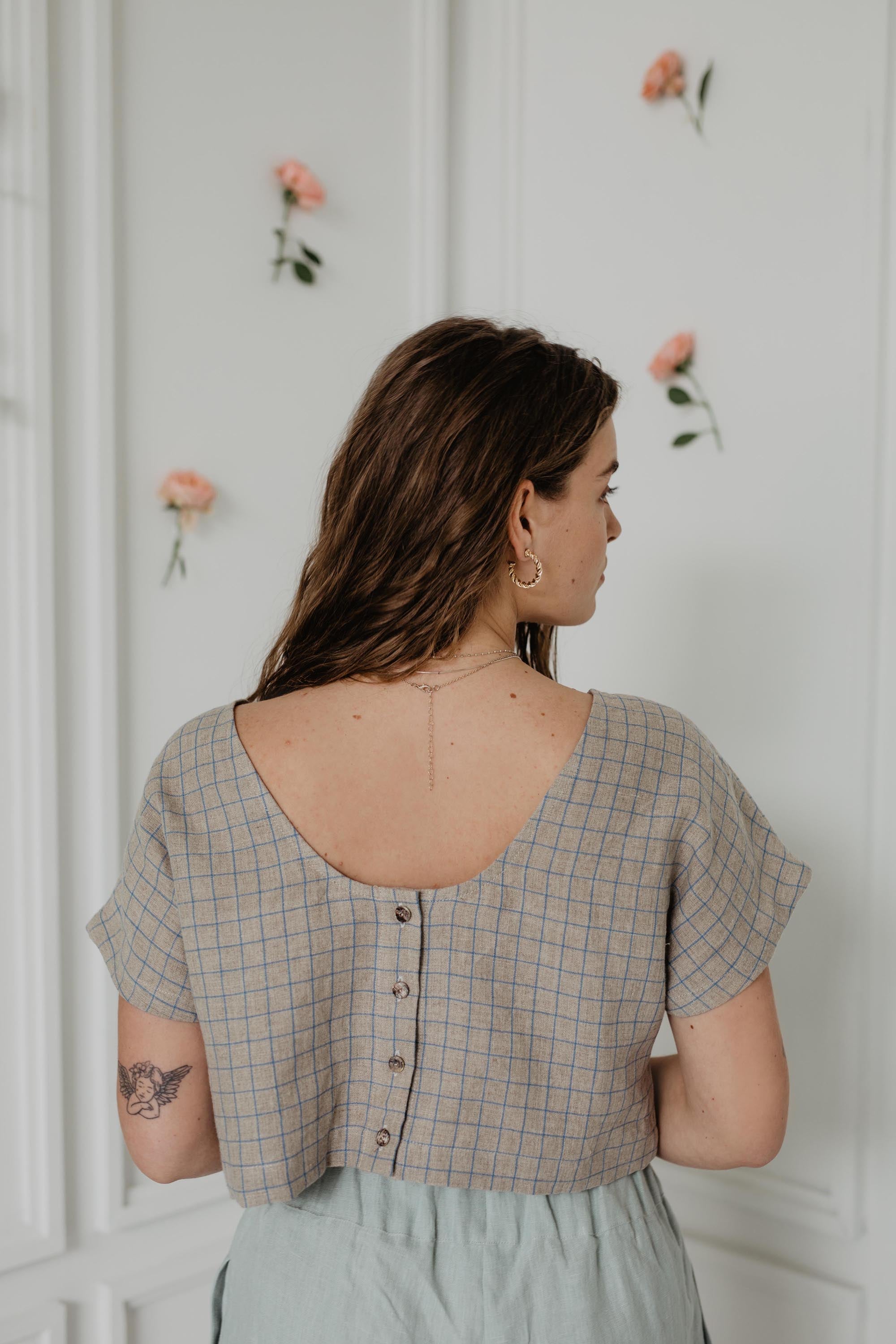 Back Of Woman Wearing A Checkered Linen Crop Top With Buttons