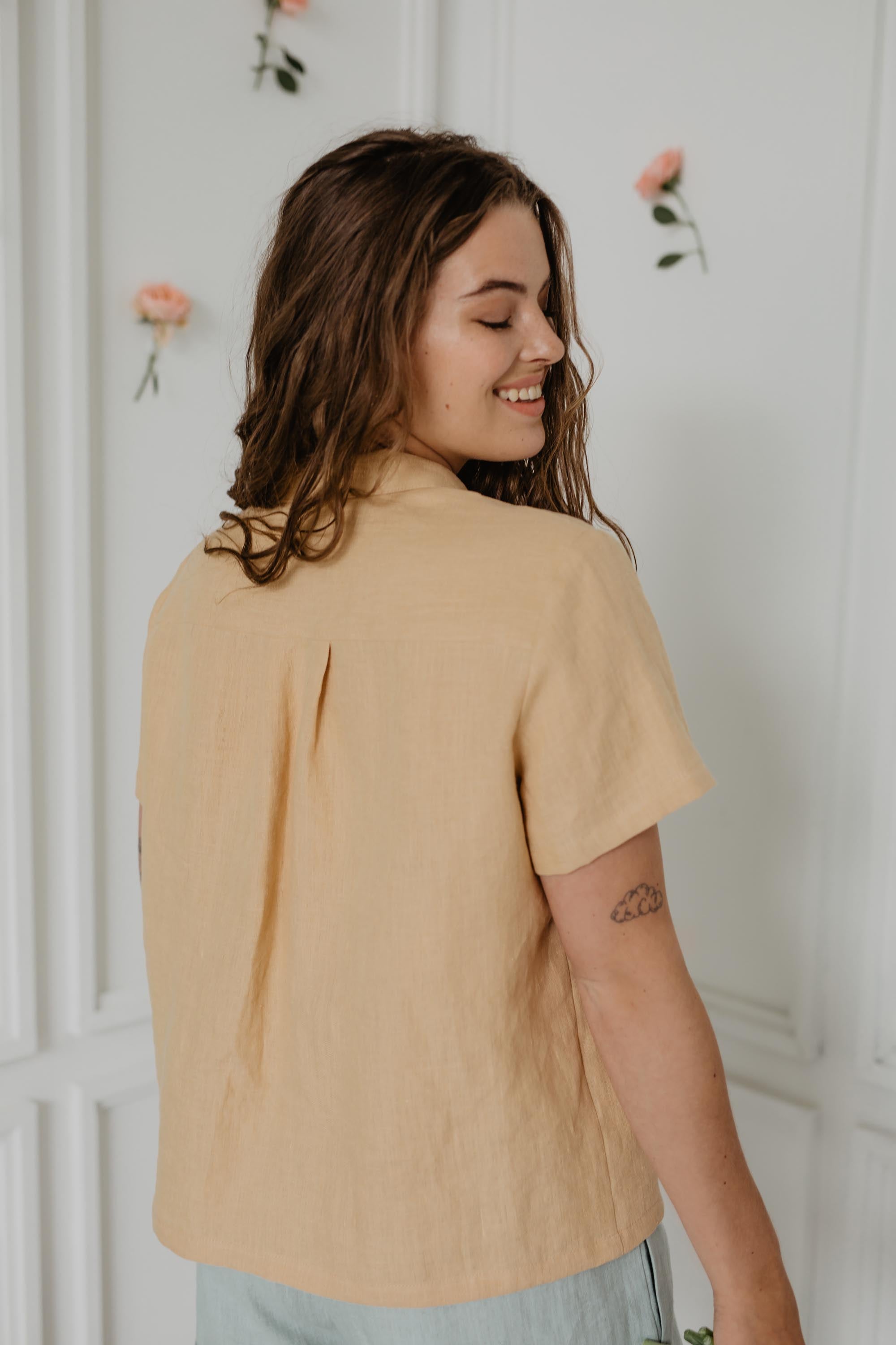 Woman Turned Back Smiling Wearing A Mustard Summer Linen Shirt
