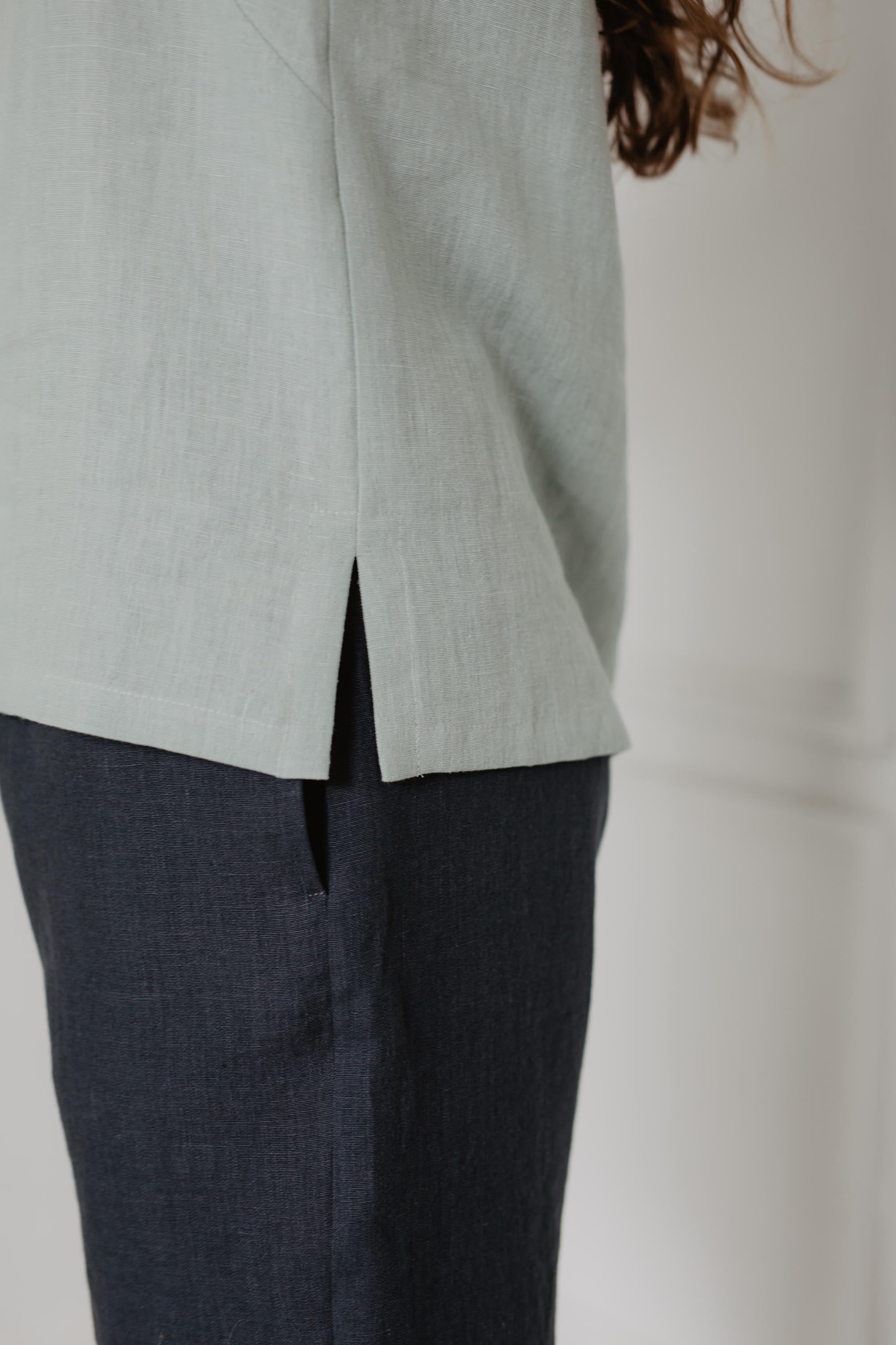 Close Up Of Sage Green Linen Top and Navy Blue Shorts Side