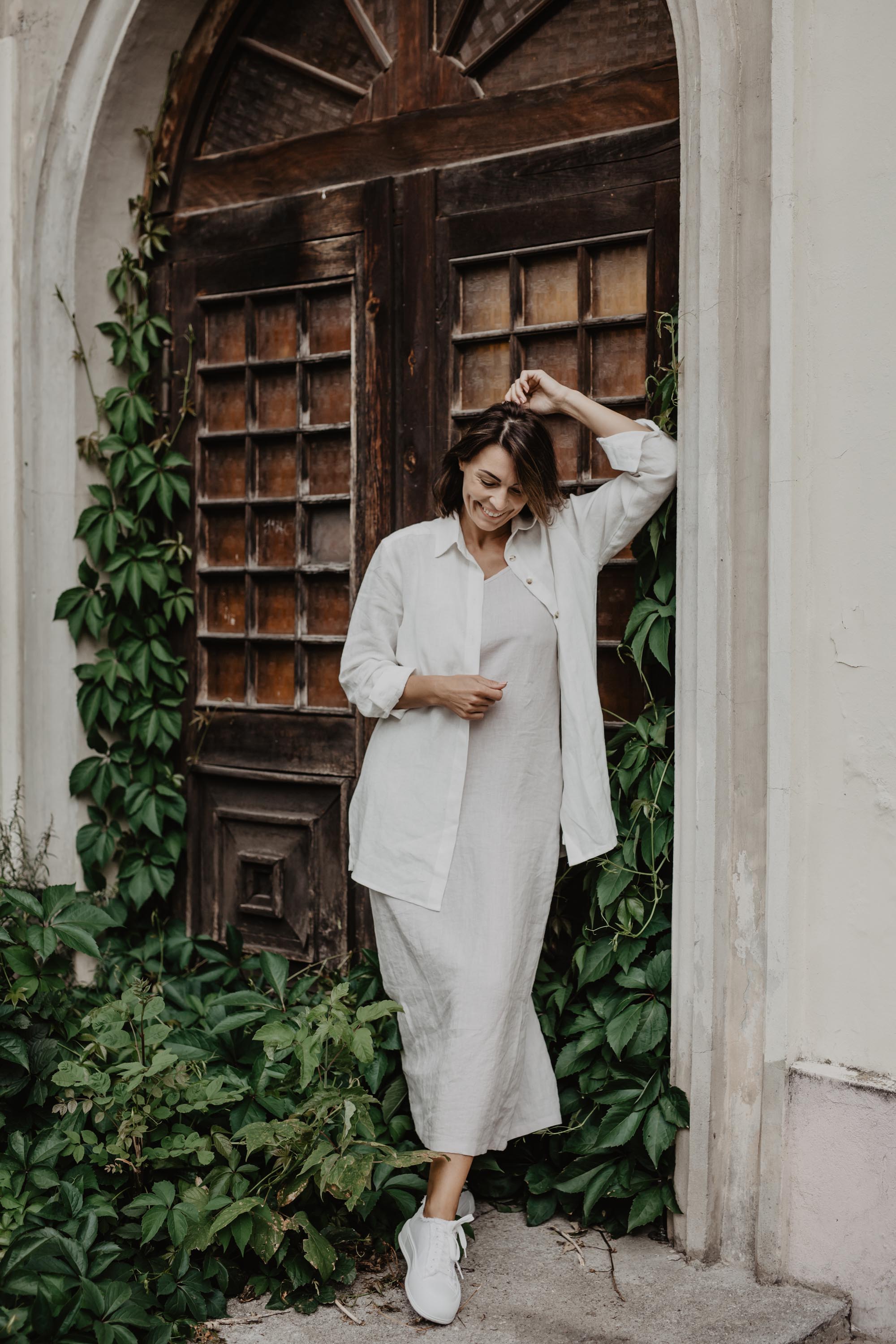 Woman Wearing A White Outfit consisting of Linen Oversized Shirt And White Linen Dress By AmourLinen