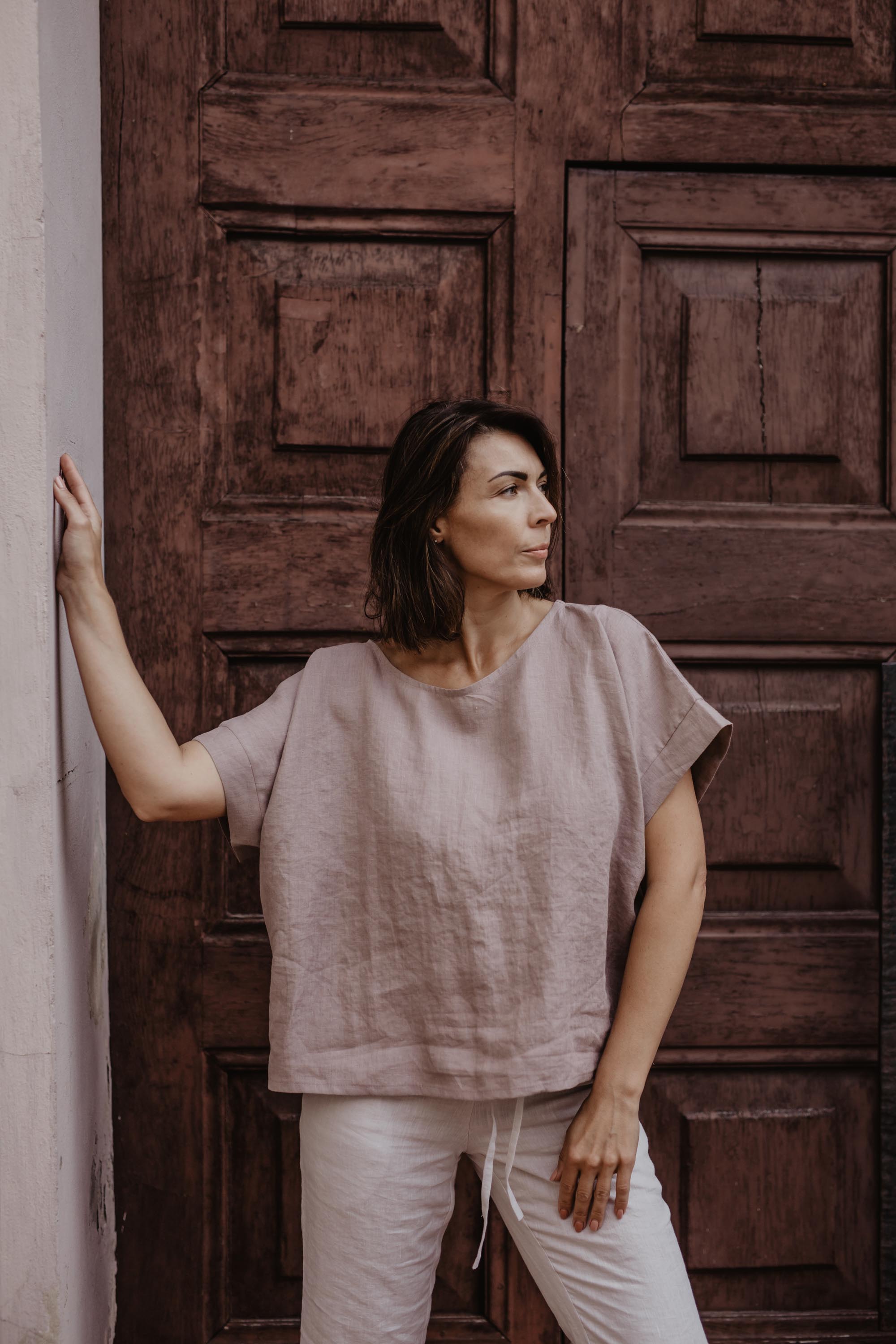 Woman INf Front Of A Door Wearing Dusty Rose Linen Top By Amourlinen