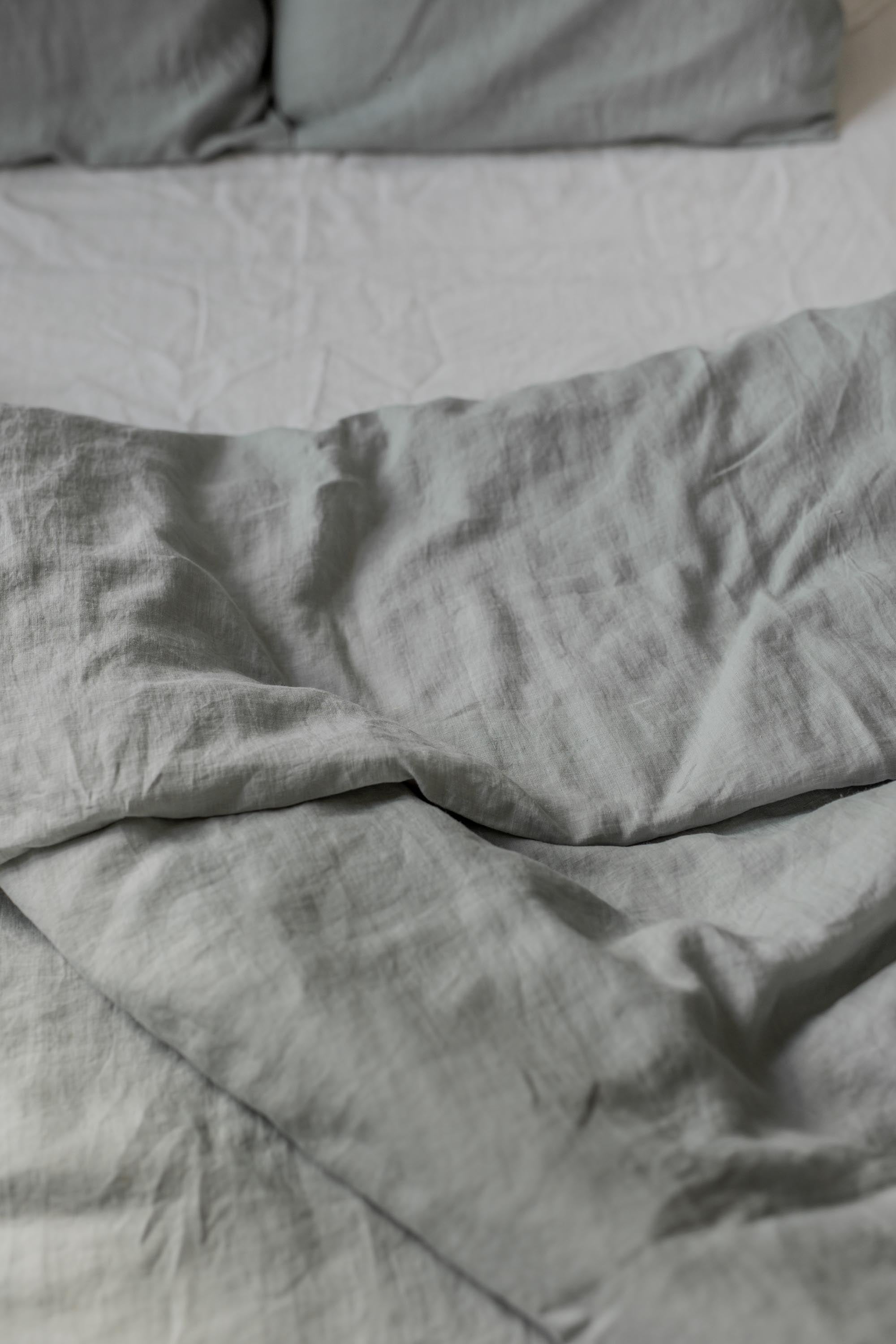 Close Up of Bed With Sage Green Linen Duvet Cover By AmourlInen