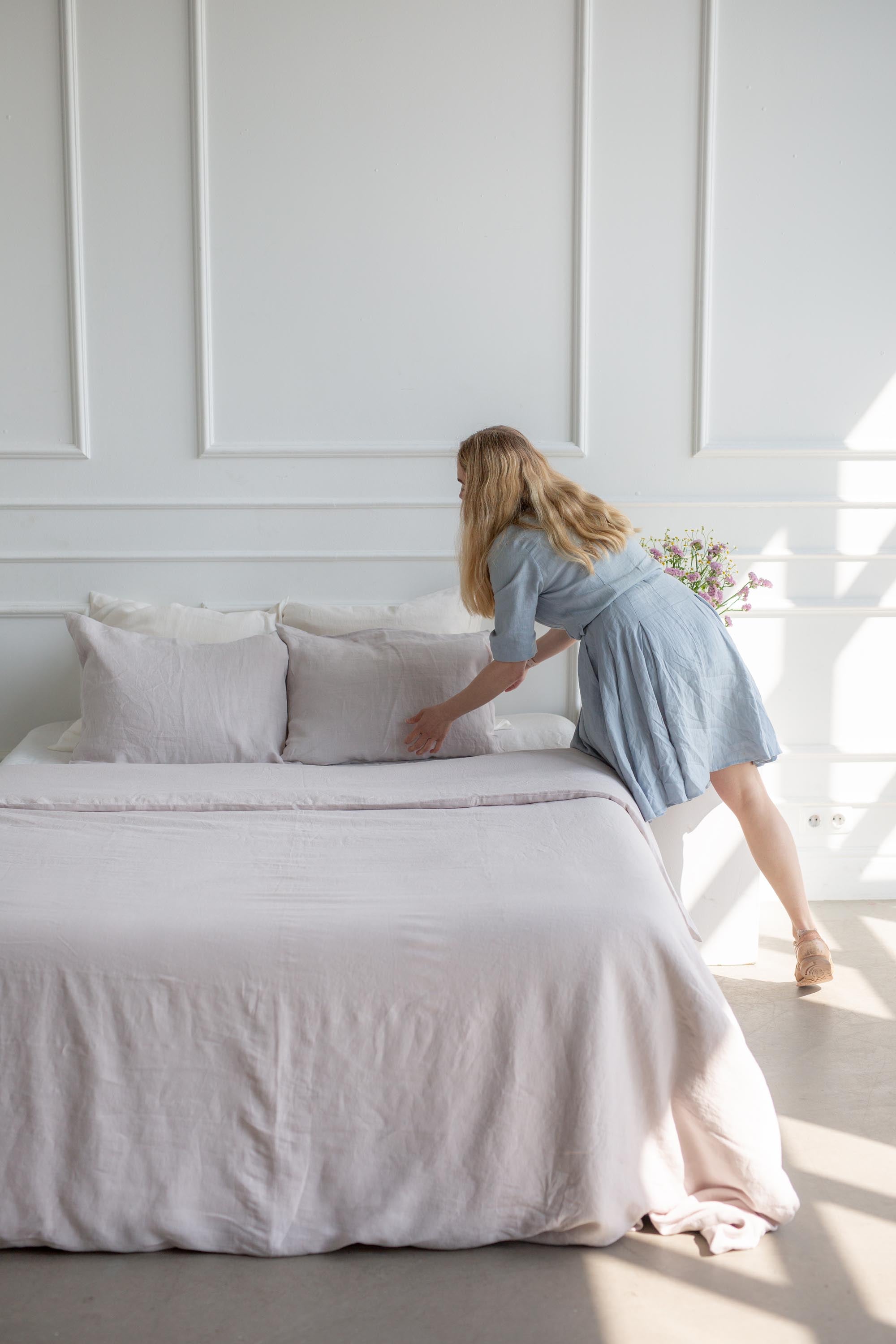Woman Tyding Cream LInen Pillowcase On Bed By AmourlInen