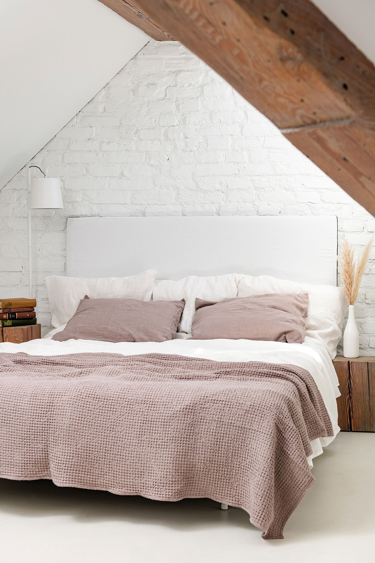 A Stylish Room With A Bed Thas has Linen Waffle Bed Throw in Rosy Brown on It By AmourlInen