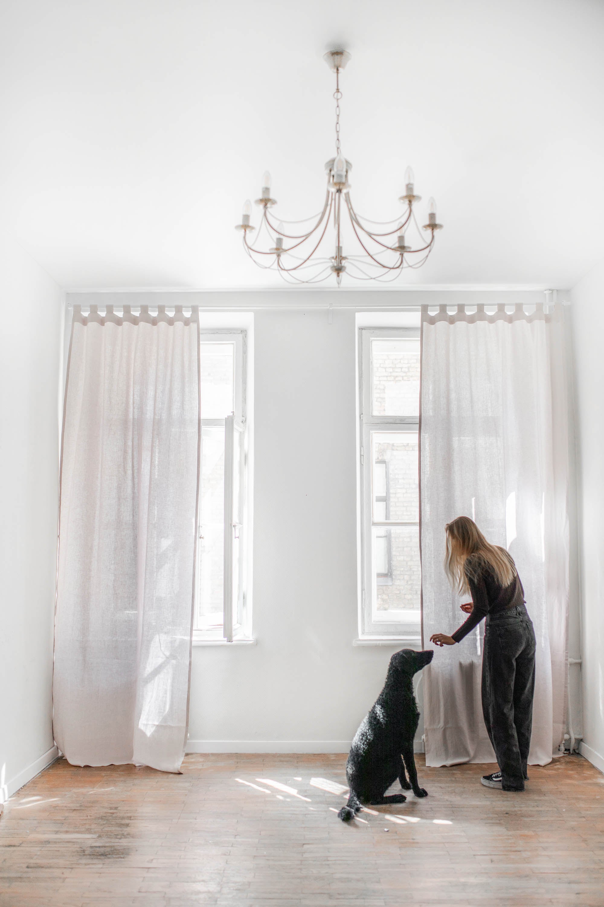 White Spacious Room WIth Cotton Candy Tab Top Linen Curtains Accompanied A Dog and Woman Playing