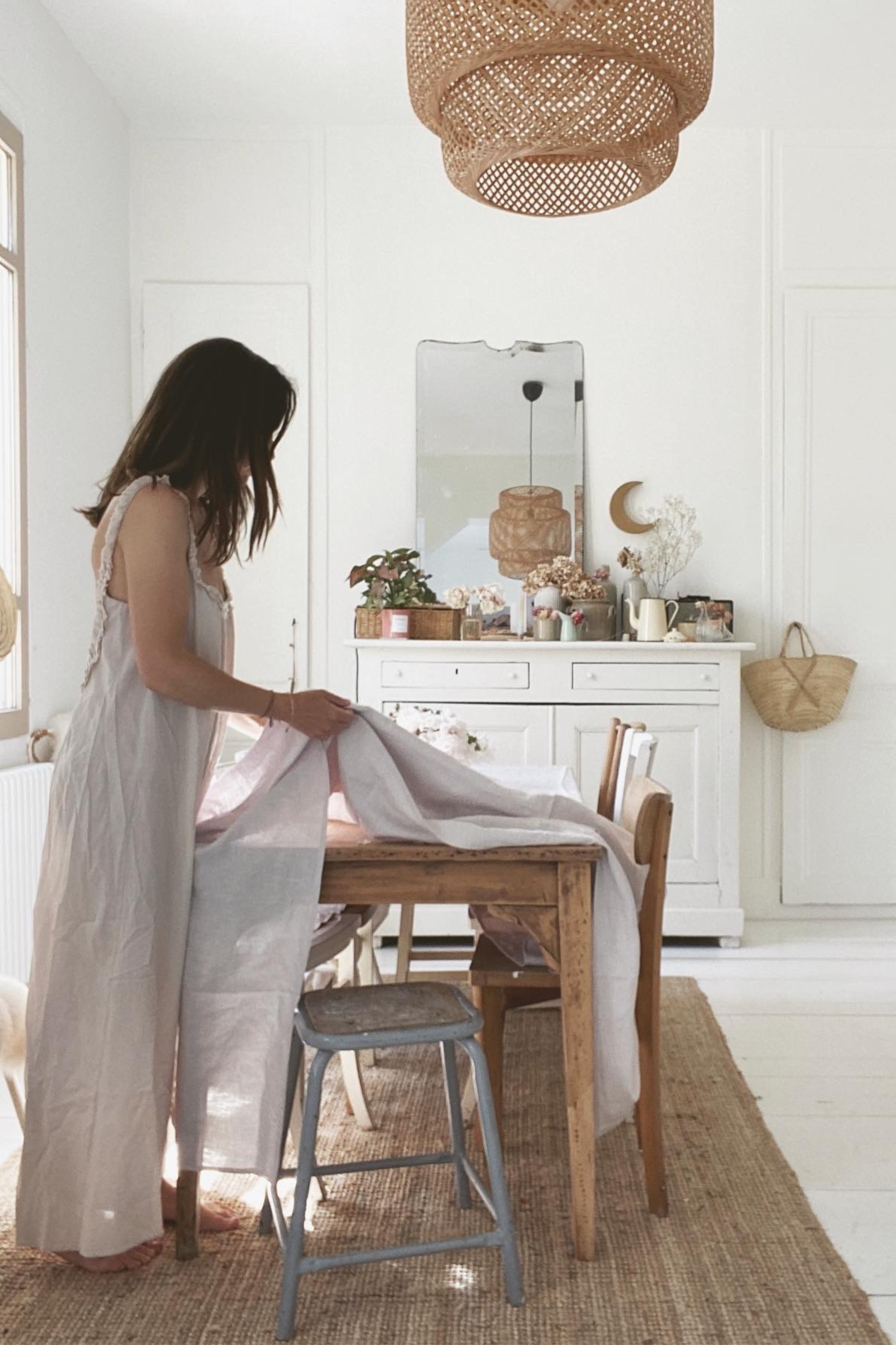 Woman Setting A Cream Linen Tablecloth By AmourLinen