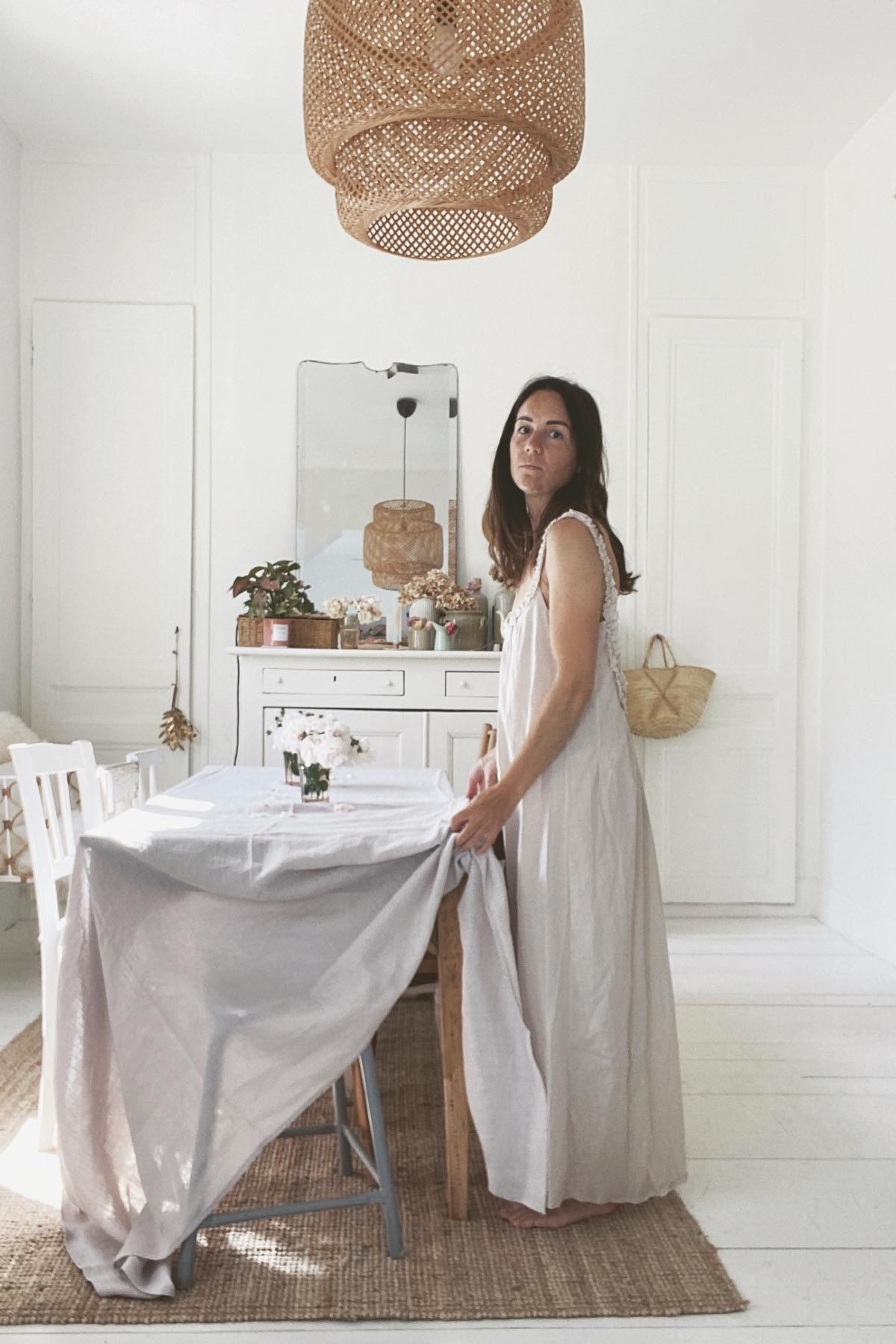 Woman Setting Dinner Table With Cream Linen Tablecloth By AmourLinen