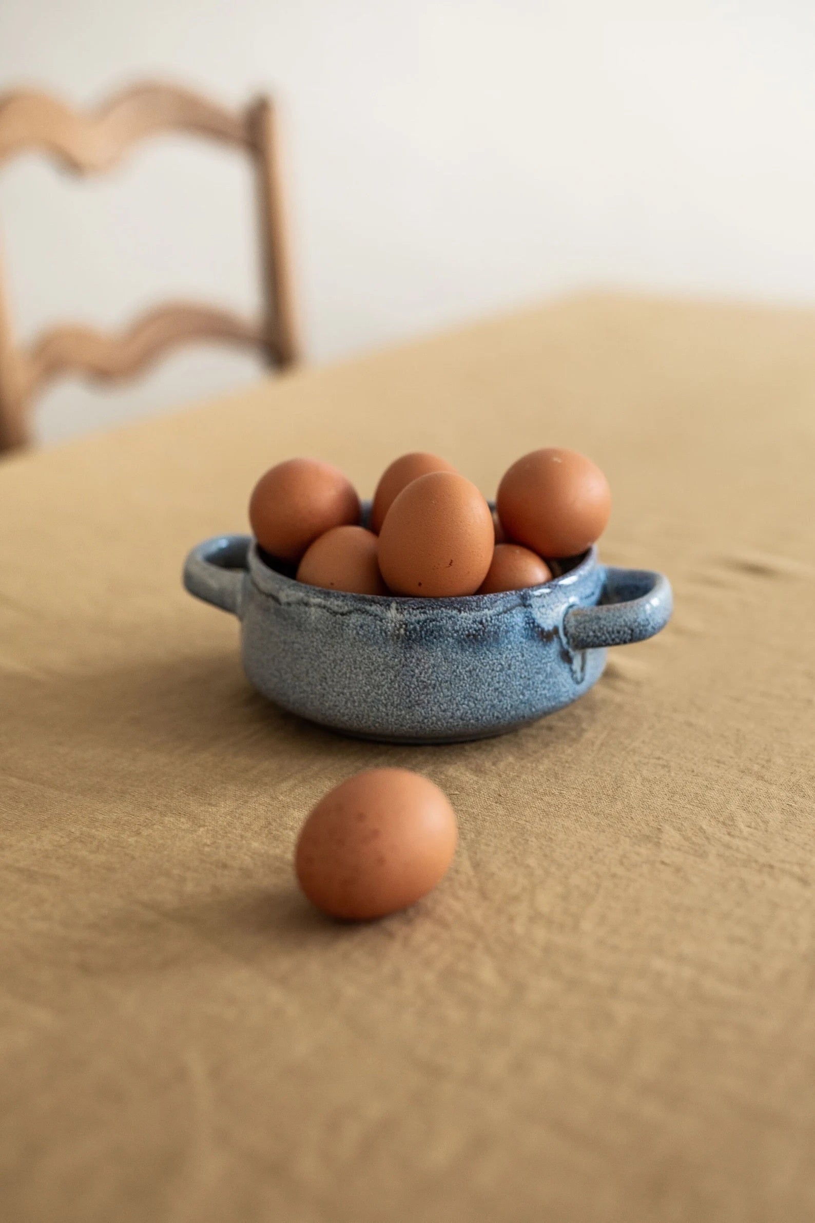 Close Up Of Eggs In A Bowl On a Mustard Color Linen Tablecloth By Amourlinen